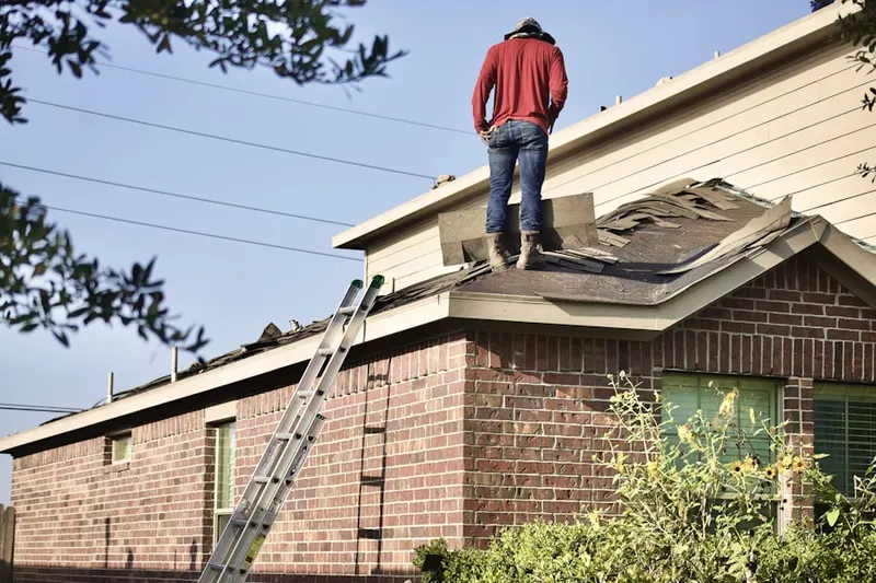 Professional roofer working on a residential roof in Northport